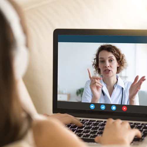 Dental practitioner holding video call with patient